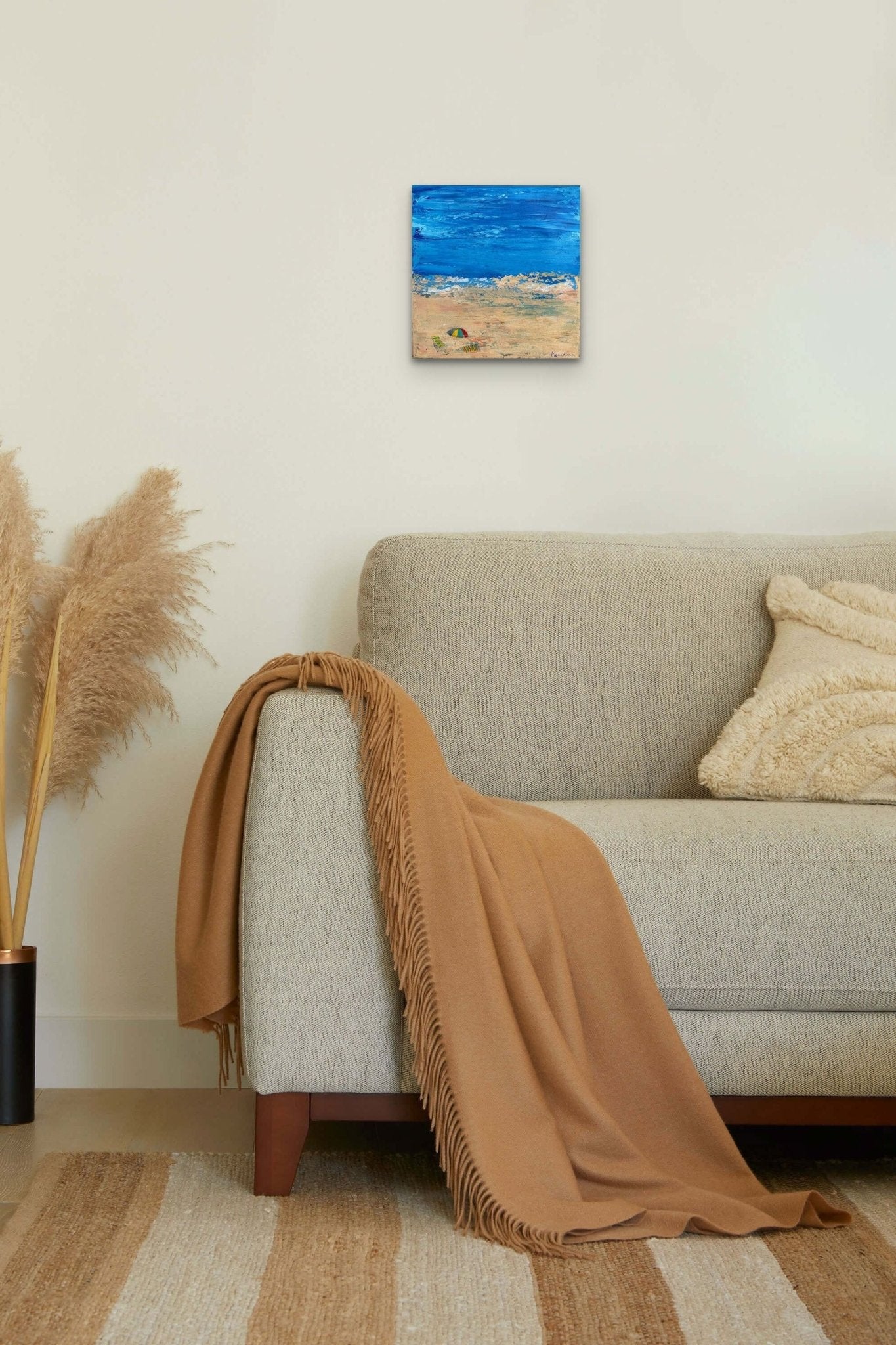 Impressionistic abstract beach painting with blue color fits well with this natural living space