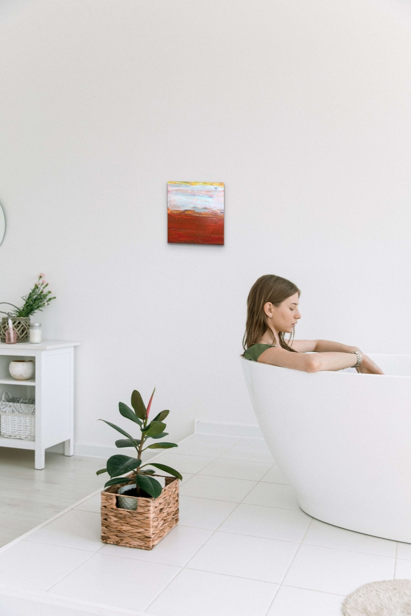Abstract artwork in red, yellow & white fills this modern bathroom with color and energy
