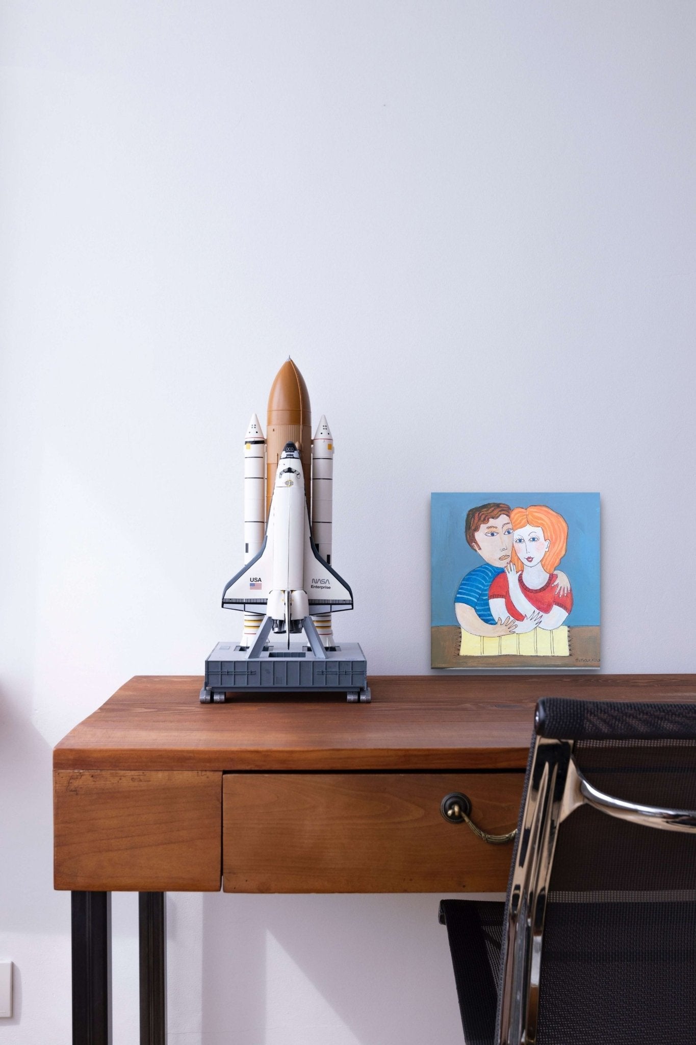 Figurative bold colored love painting of a couple with emotion adds life to this desk.