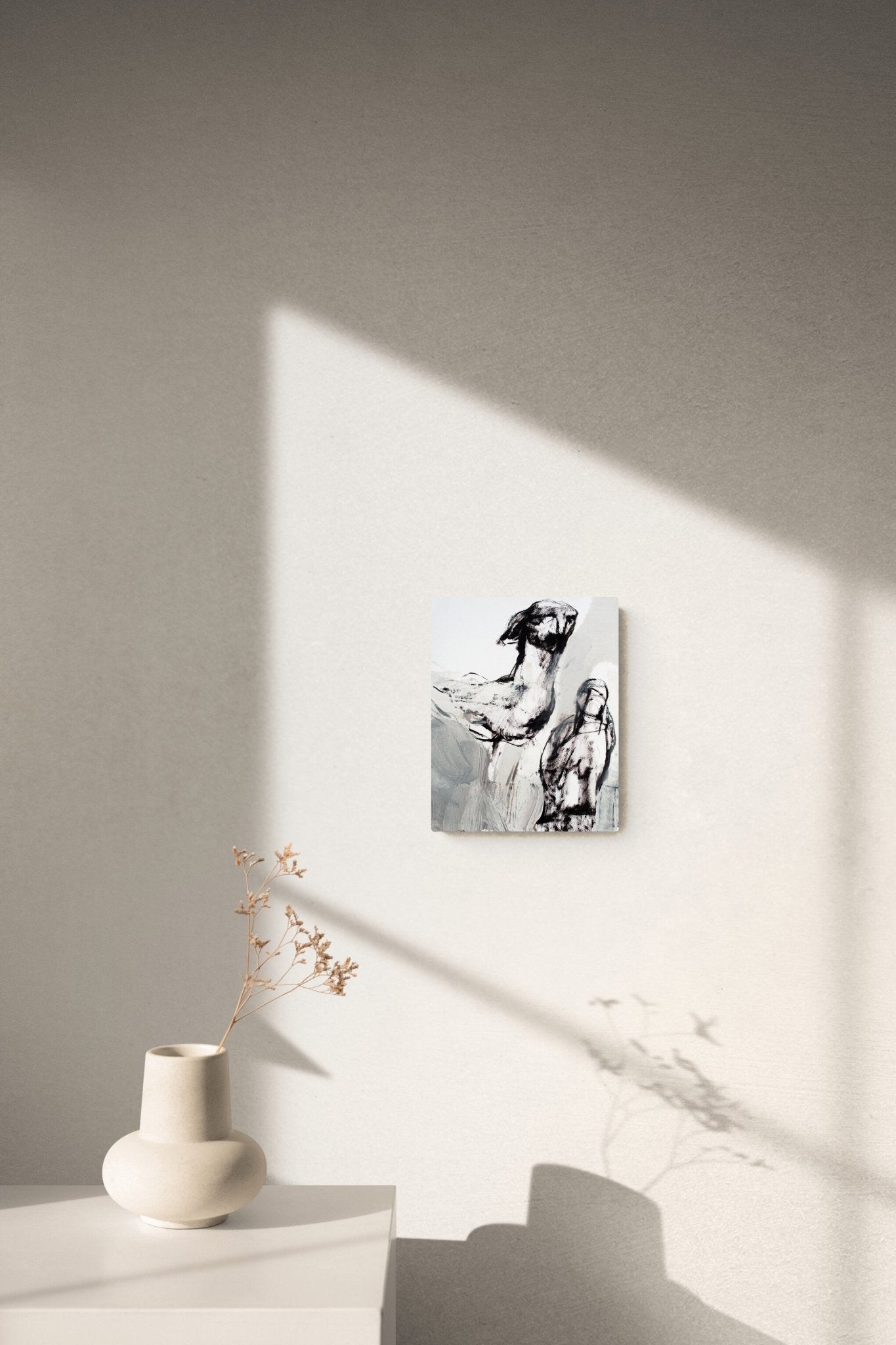 Figurative black & white painting adds conversation in the corner living room