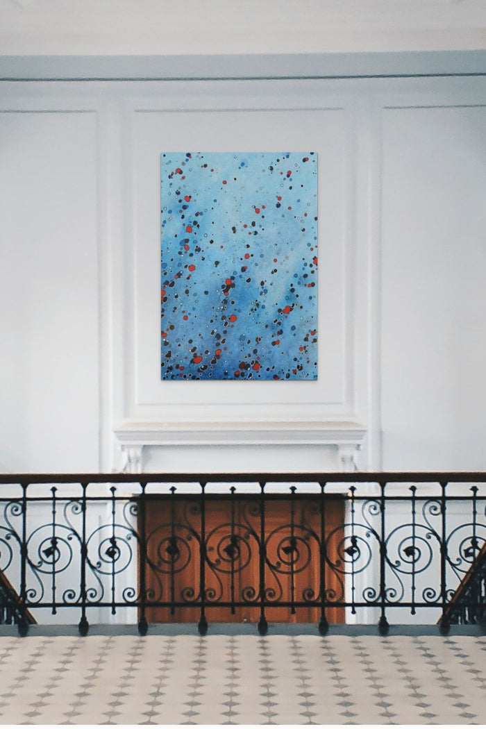 Abstract artwork with blue water shapes fills this grand hallway with life and energy
