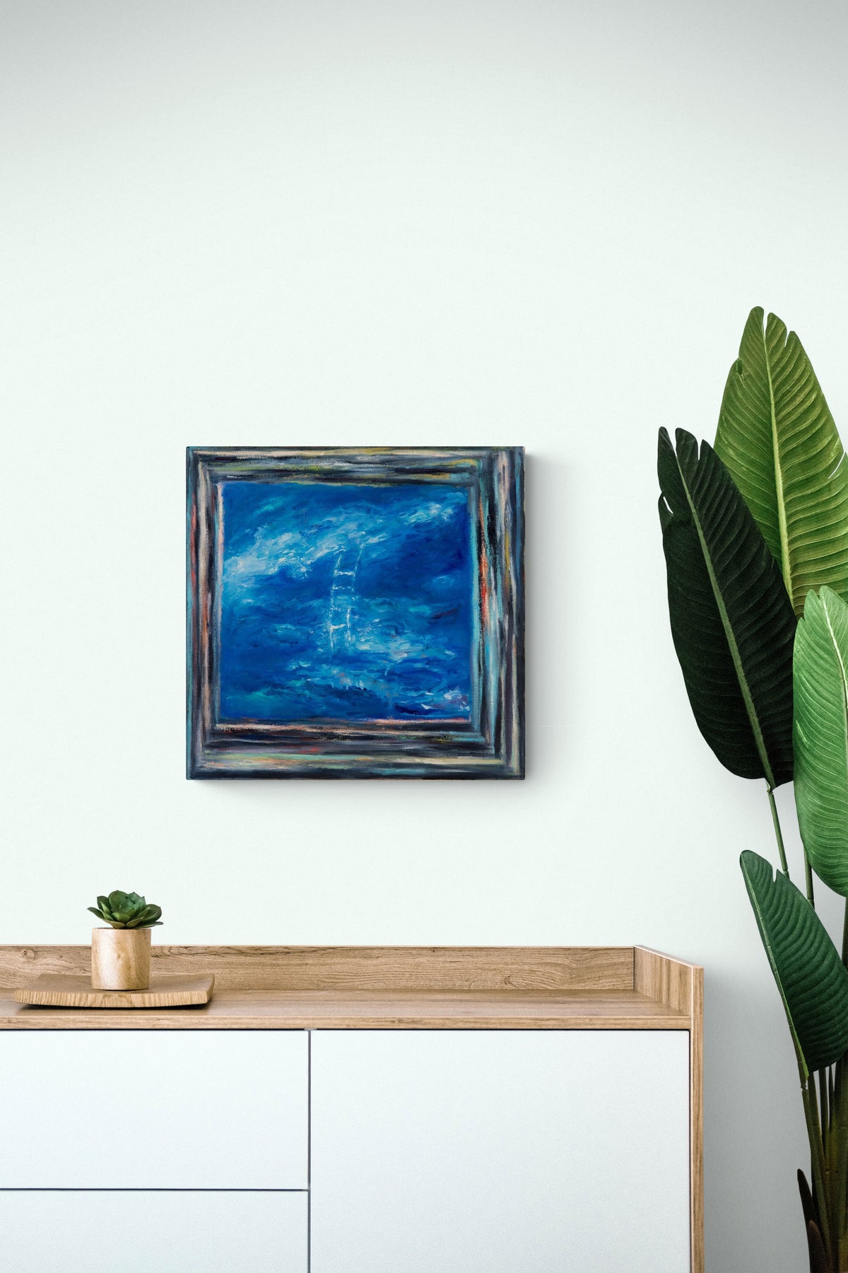 Seaside impressionistic painting brings nature & emotion in this simple natural dining room