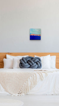 Small Impressionistic Abstract Ocean painting adds blue & texture to this natural bedroom
