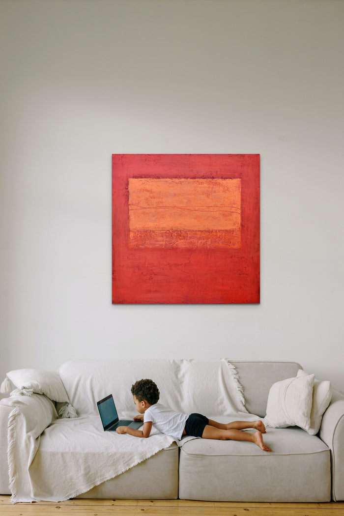 Abstract artwork in orange & red fills this cozy room with life and energy 