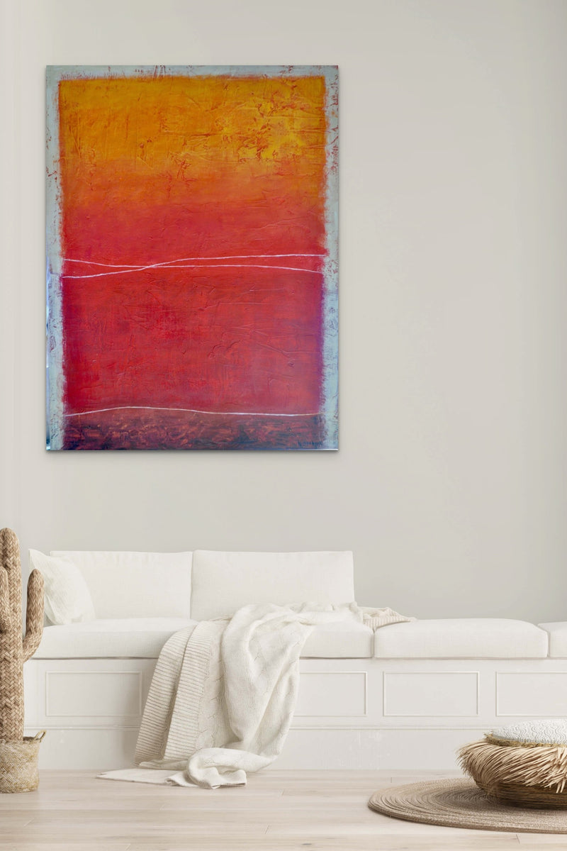 Abstract artwork with orange & red colors fills this natural inspired living space