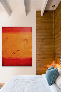 Orange & Red Abstract artwork fills this bedroom with bold color and energy 