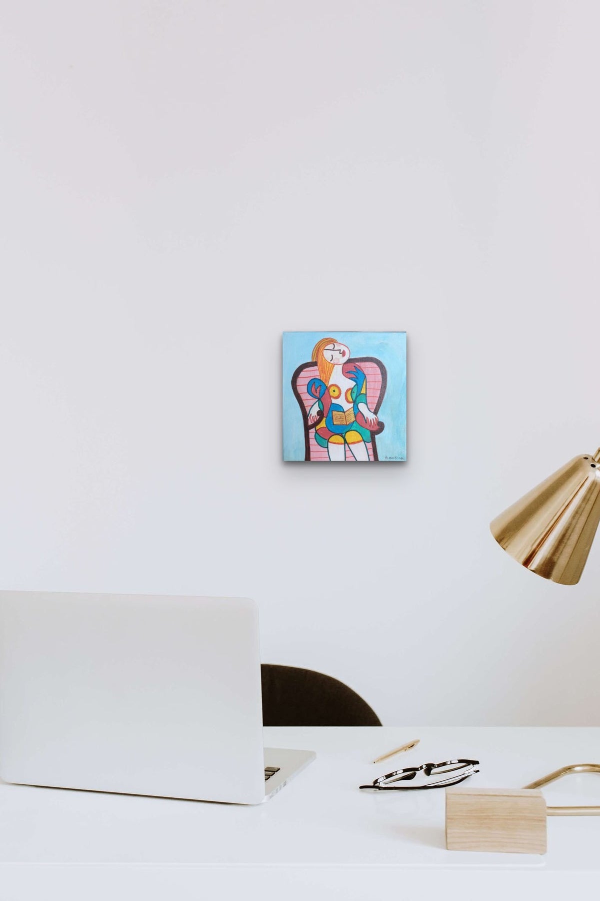 Small Picasso style Figurative Female painting adds bold colors and life to this desk area