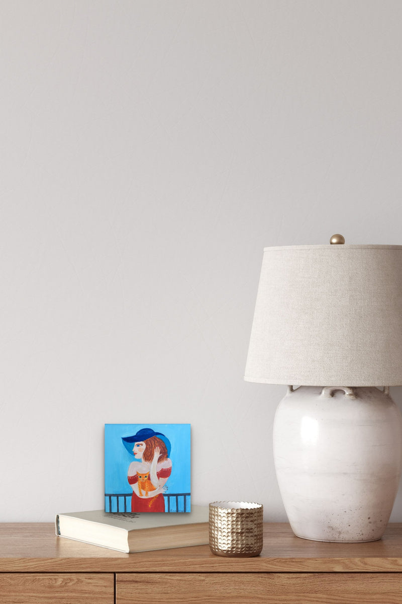 Small Female Figurative artwork with hues of blue & red colors adds life to this nightstand
